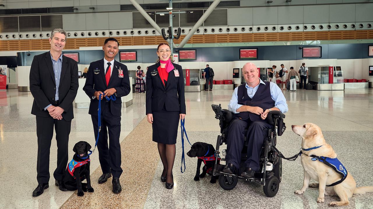 Assistance Dogs Australia chief executive Tim Taylor (left) said inconsistency and lack of education on assistance animal law causes stressful situations for people with disabilities. Photo: Qantas