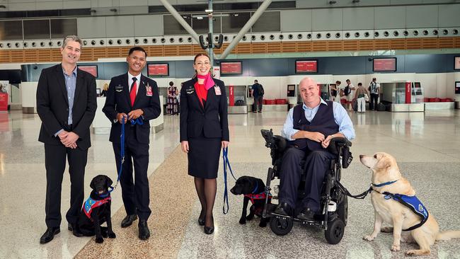 Assistance Dogs Australia chief executive Tim Taylor (left) said inconsistency and lack of education on assistance animal law causes stressful situations for people with disabilities. Photo: Qantas