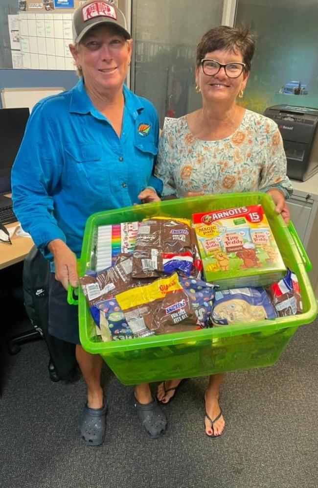 PCYC Youth Club managers Belinda Williams accepting a donation from Jo Stocker of Stockers Electrical for flood-stranded travellers at Bowen PCYC, January 2023. Photo: Contributed