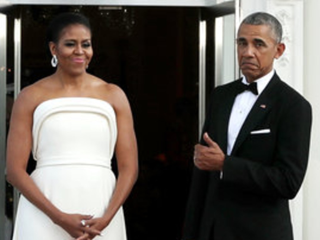 Thumbs up. Mr Obama, pictured with wife Michelle, thinks it’s time for women to run the world. Picture: Getty