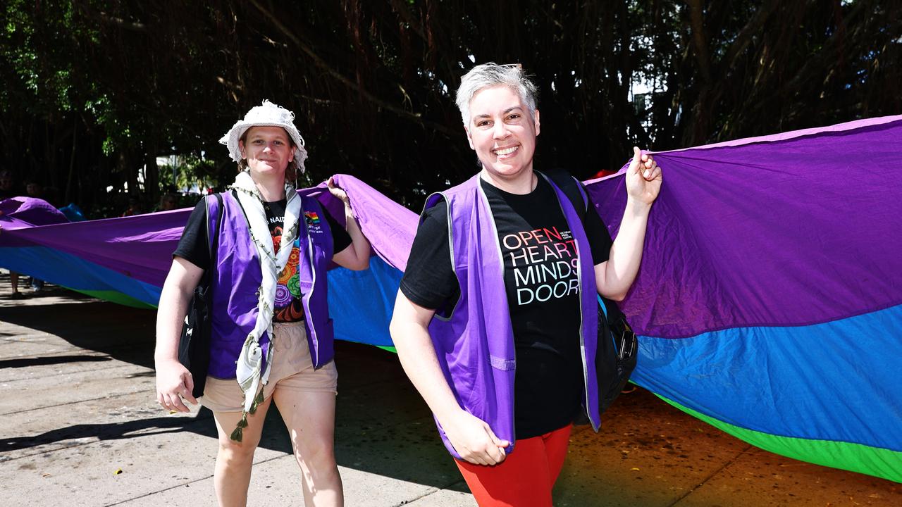 A small group of LGBTIQ people and supporters paraded along the Cairns Esplanade with a huge rainbow flag for the Pride Stride, part of the Cairns Pride Festival. Billie Stimpson and Jo Sampford hold a huge rainbow flag along the march. Picture: Brendan Radke