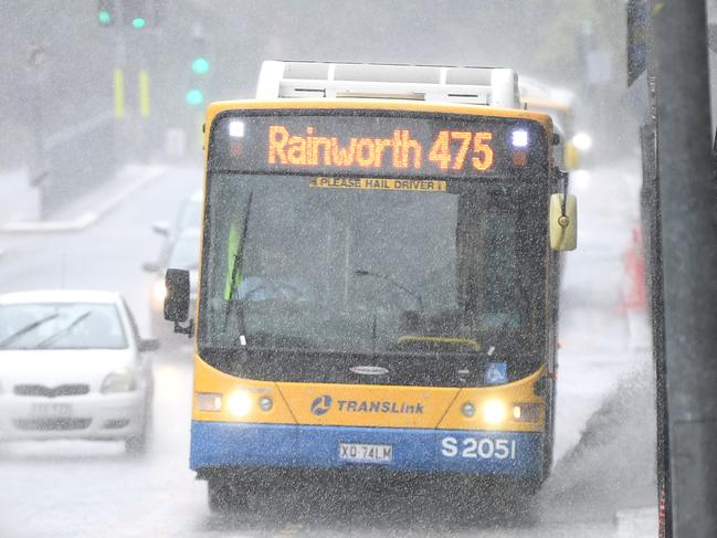 BRISBANE, AUSTRALIA - NewsWire Photos - DECEMBER 17, 2020.A bus splashes water as it makes his down Roma st during a heavy downpour of rain in Brisbane. Torrential downpours continue to batter south eastern Queensland.Picture: NCA NewsWire / Dan Peled