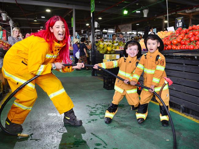 Volunteer firefighter Nada El-Masri and 5 year olds Flynn and Ollie gearing up for the Dandenong Night Market entertainment with a tug of war. Picture : Nicki Connolly