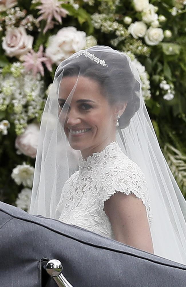 Pippa Middleton smiles at cameras as she arrives.