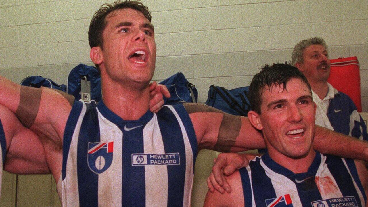 Wayne Carey and Anthony Stevens celebrate in the locker room in 1998.