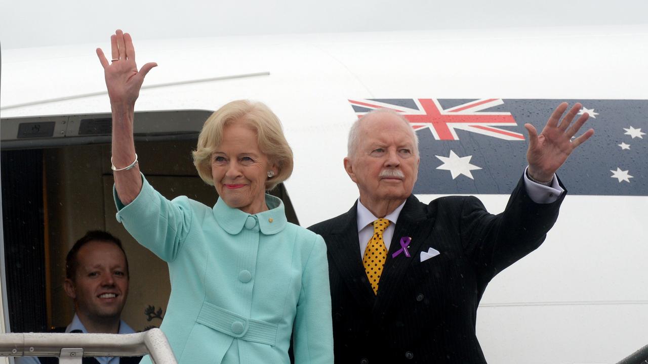 Governor General Dame Quentin Bryce and Michael Bryce wave goodbye as they board the plane at Fairbairn RAAF base in Canberra in 2014. Picture: AAP Image/Alan Porritt