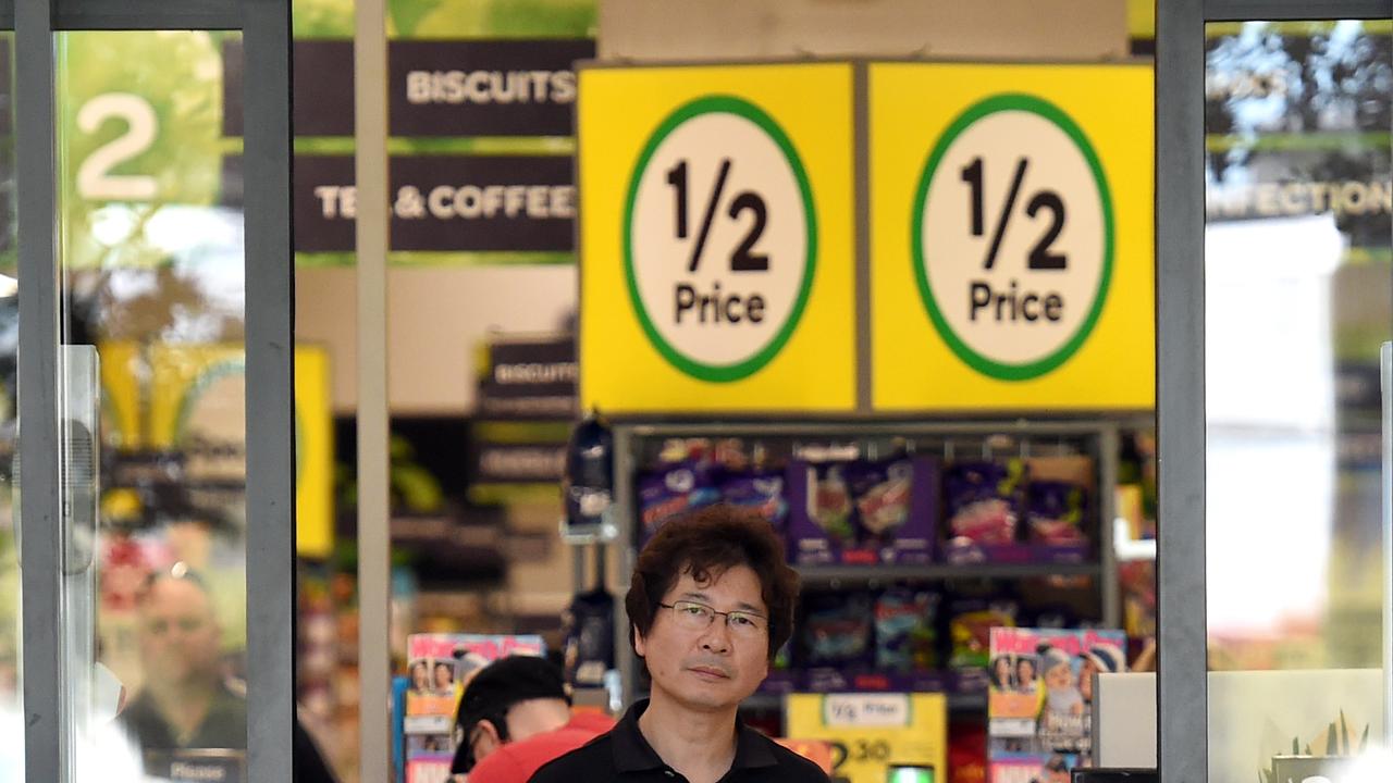 A customer leaves a Woolworths supermarket in Brisbane, Monday, July 25, 2016. Struggling supermarket giant Woolworths is axing 500 office and supply jobs and will shut underperforming stores as it seeks to improve performance and win back customers lost to rivals Coles and Aldi. (AAP Image/Dan Peled) NO ARCHIVING