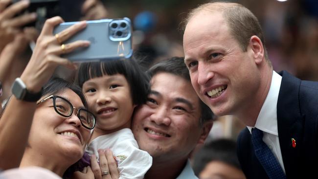 Prince William poses for a selfie with members of the public during his visit to the HSBC Rain Vortex at Jewel Changi Airport. Picture: Chris Jackson/Getty Images