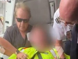 A man with a gun is apprehended on a passenger jet at Avalon Airport. Picture: Channel 7