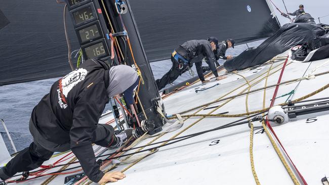 Racing aboard Master Lock Comanche is physical - and very wet. Picture: Andrea Francolini