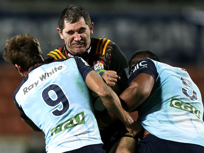 Chiefs centre Stephen Donald is crunched by the Waratahs defence on Saturday night.