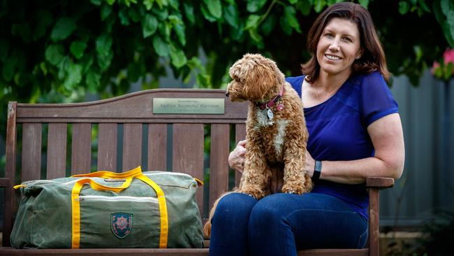 Kellie Harrison with her late husband Andrew’s fire gear on a bench dedicated in his honour. Picture: Matt Turner.