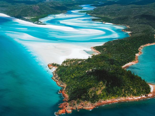 Shallow clear water at Whitsunday Island's beach. Picture: Tourism and Events Queensland