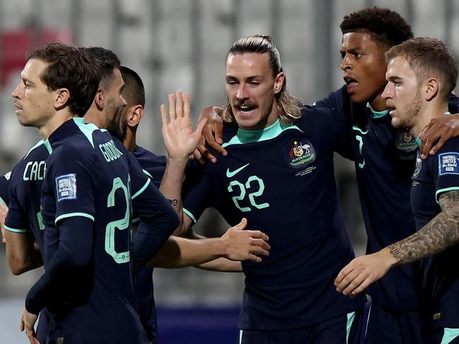 MANAMA, BAHRAIN - NOVEMBER 19: Kusini Yengi of Australia celebrates with teammates after scoring his team's first goal during the FIFA World Cup Asian 3rd Qualifier Group C match between Bahrain and Australia on November 19, 2024 in Manama, Bahrain. (Photo by Christopher Pike/Getty Images)