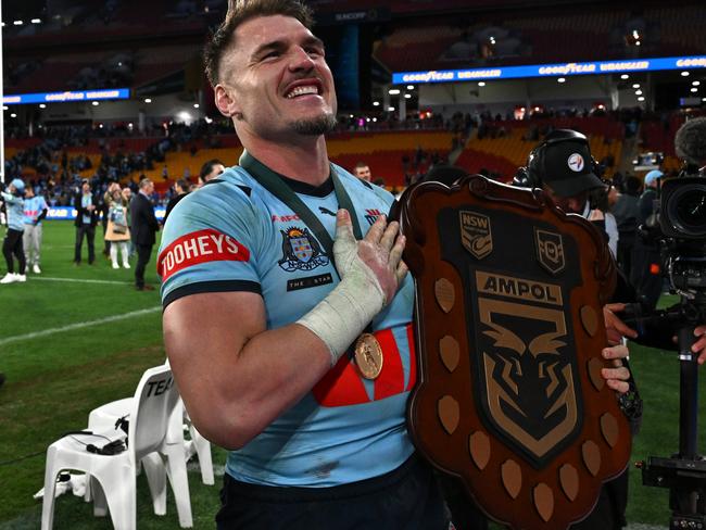 BRISBANE, AUSTRALIA - JULY 17: Angus Crichton of the Blues poses with the State of Origin Shield after winning the series 2-1 after game three of the 2024 Men's State of Origin series between Queensland Maroons and New South Wales Blues at Suncorp Stadium on July 17, 2024 in Brisbane, Australia. (Photo by Bradley Kanaris/Getty Images)