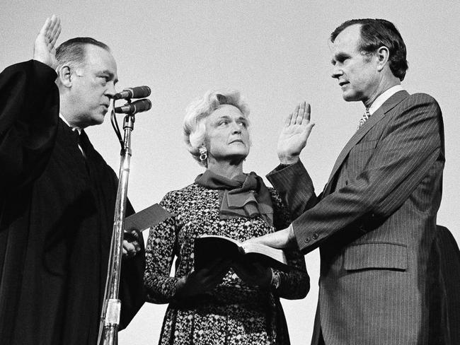 George H.W. Bush is sworn in as the new director of the CIA by Supreme Court Associate Justice Potter Stewart as Barbara Bush looks on, January 1976. Picture: AP Photo