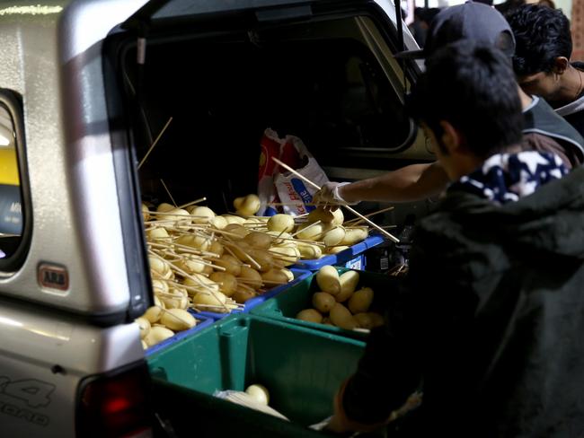 Potatoes being unloaded from the back of a car, ready to be cooked. Picture: Damian Shaw