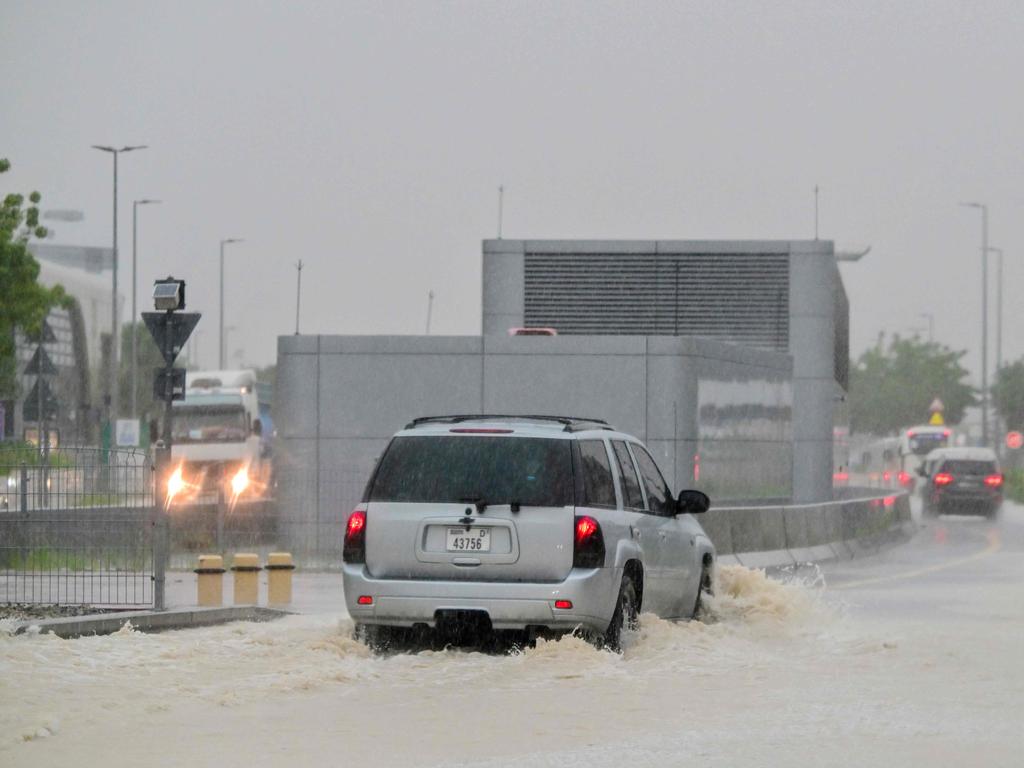 Vehicles drive on a flooded road during torrential rain as the death toll from storms in Oman rose to 18, many of them children. Picture: Giuseppe CACACE / AFP