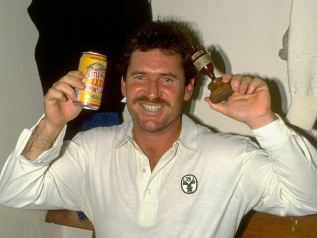 Allan Border of Australia holds up the ashes in the dressing room after the Sixth Test against England at the Oval in 1989. Picture: Adrian Murrell/Allsport