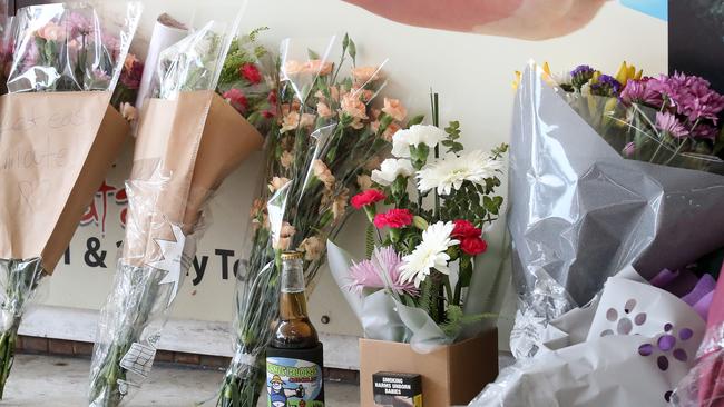 Flowers, beer and cigarettes left by friends of murder victim Jack Beasley as they gather to pay their respects at the scene of the tragedy outside the Surfers Paradise IGA. Photographer: Liam Kidston.