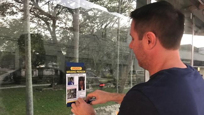 Panoptic Solutions founder Troy Claydon posts up 'missing person' posters around Penang, Malaysia, where Annapuranee Jenkins vanished on Dec. 13, 2017. Mr Claydon is heading up the family's hunt to try and find her.