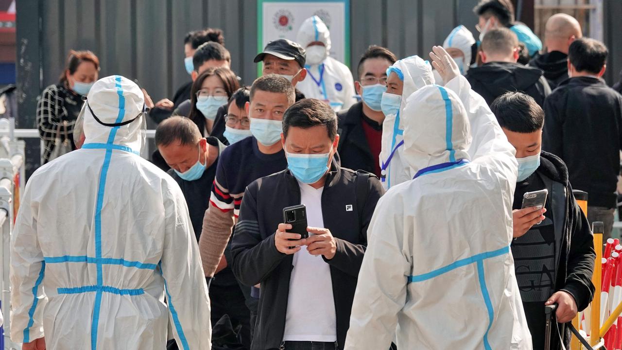 Health workers guide travellers to a Covid-19 coronavirus inspection station at Yantai Railway Station in China's eastern Shandong province. Picture: AFP