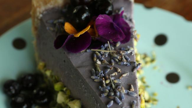 Lime, Blueberry, Lavender tart with edible flowers served at Cardamom Pod Vegetarian restaurant, Broadbeach, Gold Coast. Picture: Regi Varghese