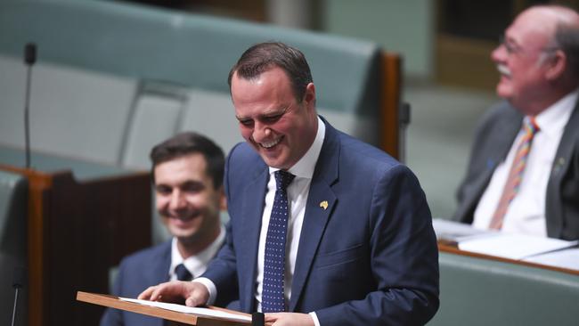 Liberal MP Tim Wilson reacts after proposing to his partner Ryan Bolger (not pictured) during debate of the Marriage Amendment bill in the House of Representatives at Parliament House in Canberra, Monday, December 4, 2017. (AAP Image/Lukas Coch) NO ARCHIVING