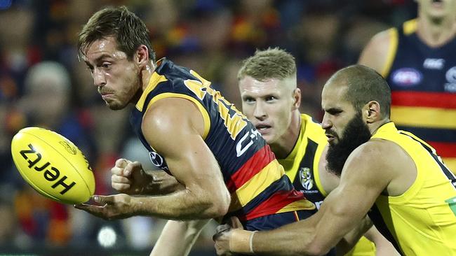 Adelaide Crows’ Richard Douglas under pressure from Richmond’s Bachar Houli. Picture: Sarah Reed