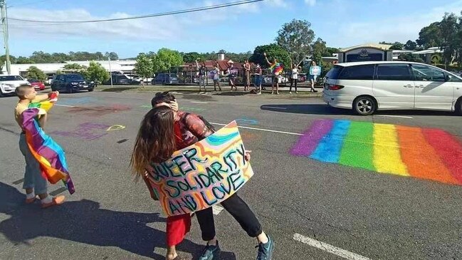 Protesters kiss outside Citipointe Christian College on Monday.