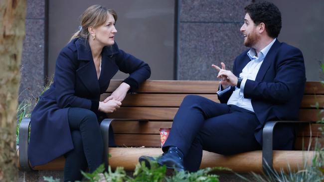 Allegra Stratton (L), 10 Downing street Press Secretary speaks to a colleague in central London. Picture: AFP.