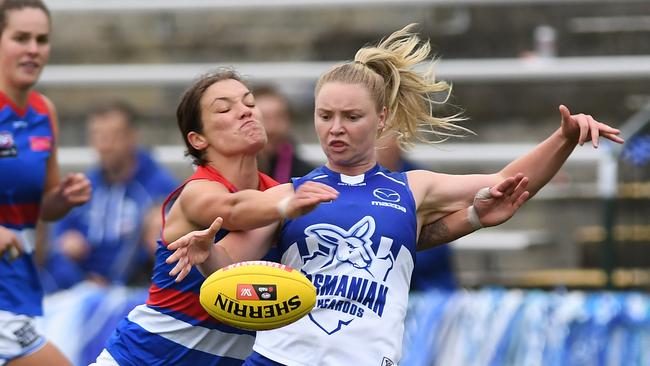 HOBART, AUSTRALIA - MARCH 13: Daria Bannister of the Kangaroos is tackled during the round seven AFLW match between the North Melbourne Kangaroos and the Western Bulldogs at North Hobart Oval on March 13, 2021 in Hobart, Australia. (Photo by Steve Bell/Getty Images)