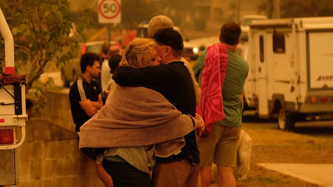 Locals seek refuge on the Malua Bay main beach in NSW as the fire approaches. Picture: Alex Coppel