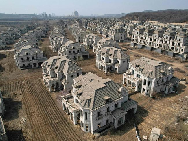 -- AFP PICTURES OF THE YEAR 2023 --  This aerial photo taken on March 31, 2023 shows deserted villas in a suburb of Shenyang in China's northeastern Liaoning province.. China's real estate industry grew at lightning speed from the late 90s, and was a major component of the country's turbocharged economic expansion. But with growth slowing and debts swelling, authorities cut off access to easy loans in 2020, pummelling the sector and causing a record-breaking slump last year. Cattle wander between the concrete shells of half-finished mansions in northeastern China, some of the only occupants of a luxury complex whose crumbling verandas and overgrown arches are stark symbols of a housing market crippled by its own excess. (Photo by Jade GAO / AFP) / AFP PICTURES OF THE YEAR 2023