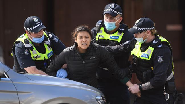 Police detain an anti-lockdown protester on Sunday in Melbourne. Picture: AFP