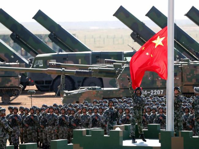 In this photo released by China's Xinhua News Agency, Chinese People's Liberation Army (PLA) troops perform a flag raising ceremony Sunday, July 30, 2017 for a military parade to commemorate the 90th anniversary of the founding of the PLA on Aug. 1 at Zhurihe training base in north China's Inner Mongolia Autonomous Region. (Pang Xinglei/Xinhua via AP)