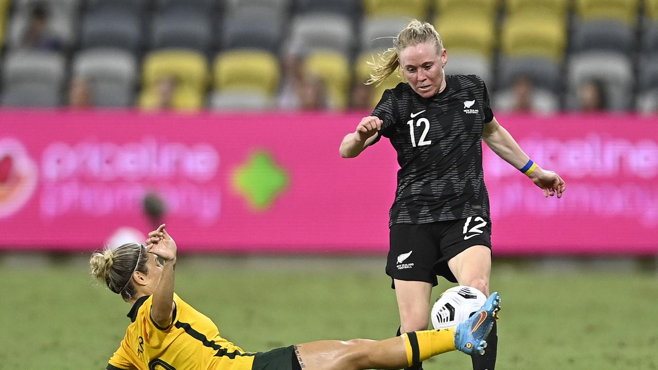 Australia’s Katrina Gorry tackles New Zealand’s Betsy Hassett in the Matildas’ 2-1 win in Townsville. Picture: Ian Hitchcock/Getty Images