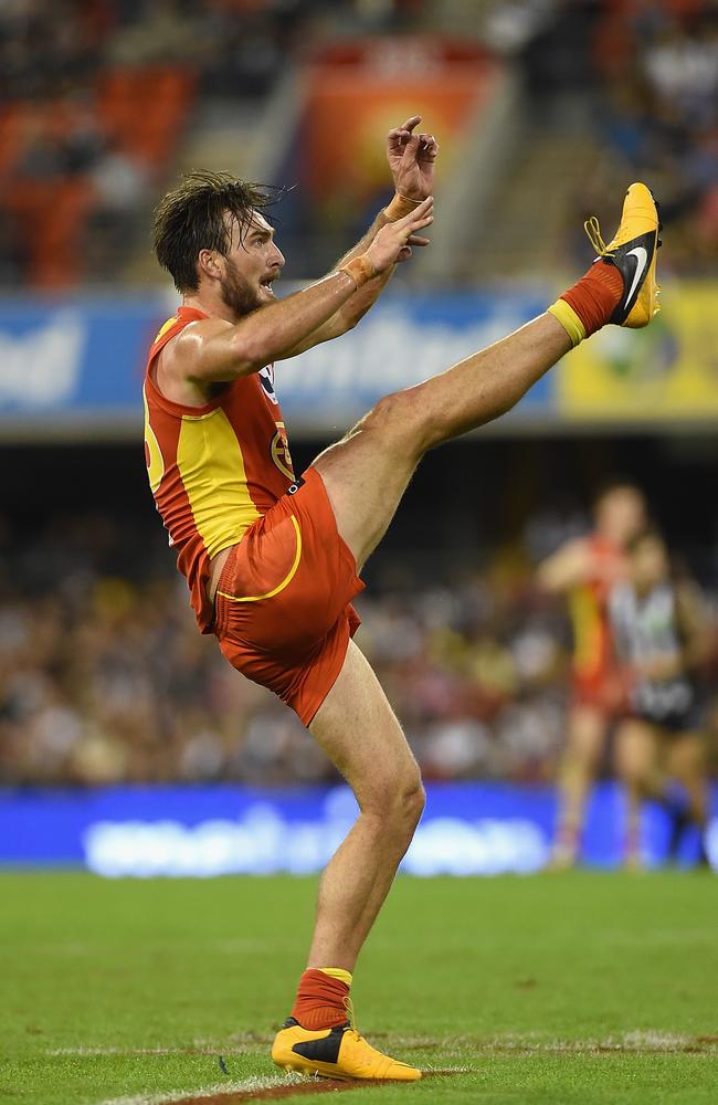 Charlie Dixon watches his kick go through the sticks for a goal.