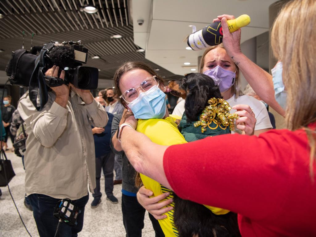 McKeown’s family, including her dog, Ottis, were on hand to greet the champion at Brisbane airport. Picture: Brad Fleet/News Corp Australia