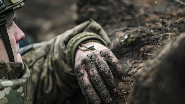 A Ukrainian serviceman takes cover in a trench near Bakhmut. Picture: AFP