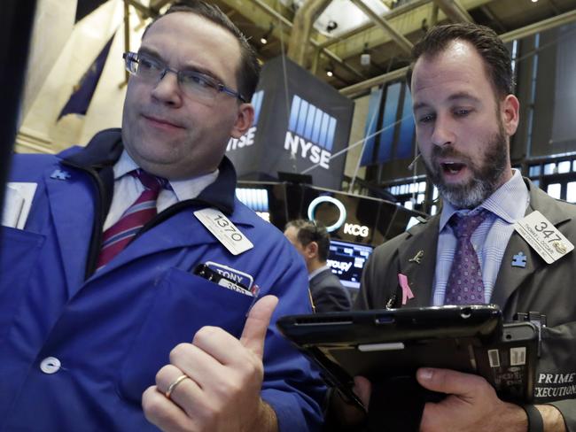 Specialist Anthony Matesic, left, and trader Thomas Cicciari work on the floor of the New York Stock Exchange, Friday, Feb. 12, 2016. U.S. stocks opened higher, seeking their first gain this week, as beaten-down energy and financial companies rebounded. (AP Photo/Richard Drew)