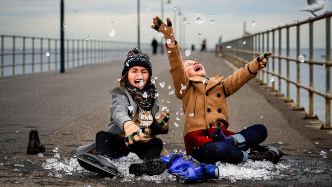 Gracie Centenera, 8, and George Archontidis, 7, get into the festival spirit with ice and skates on the Glenelg Jetty. Pic: Mike Burton