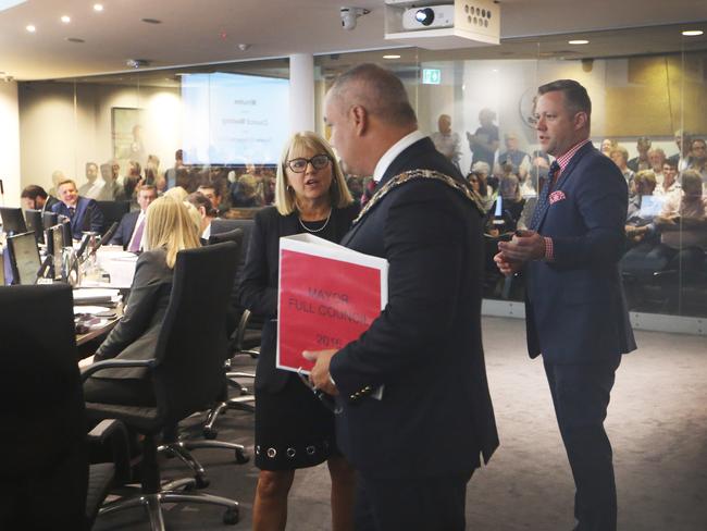 Protestors, including members of the Main beach Asociation, inside Gold Coast City Council objecting to Sunlands Hi Rise proposal at the Spit. Deputy Mayor Donna Gates in last minute talks with the Mayor Tom Tate and Cameron Caldwell before the meeting begins. Picture Glenn Hampson