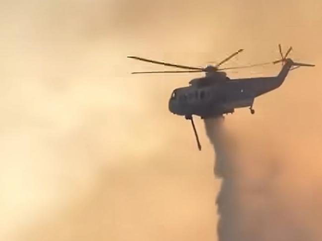 A helicopter drops water on a bushfire burning in the  Grampians. picture: Lexton CFA / Facebook