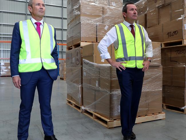 Premier of Western Australia Mark McGowan (right) and Western Australia Health Minister Roger Cook are seen touring a warehouse with a State Government consignment of PPE that has recently. Picture: AAP.