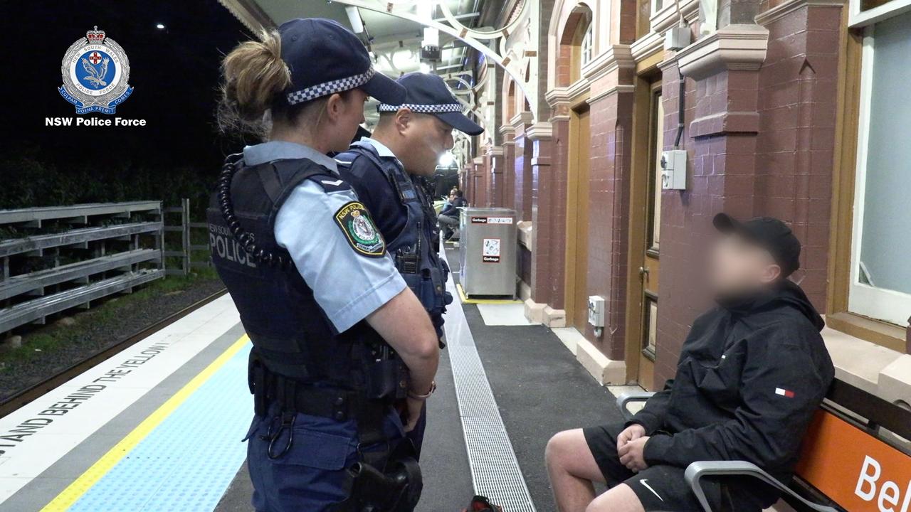 Police speak to a man at a train station during high-visibility patrols. Picture: NSW Police