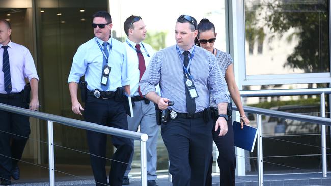 Police at the ‘boiler room’ at 130 Bundall Road, Bundall. Photo: Kit Wise