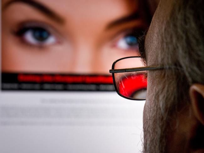 (FILES) - A file picture taken on February 10, 2014 shows a man as he looks at a dating site on his computer in Washington,DC. A hacker group made good on its pledge to release user data stolen from the affair dating website Ashley Madison, creating a potential privacy and security debacle for millions. Security experts said August 19, 2015 the files on some 32 million members of the website appeared to be genuine. Ashley Madison parent company Avid Life Media called the leak 