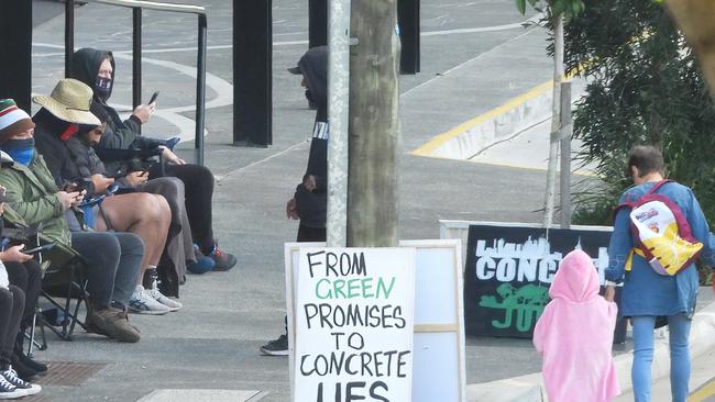 Masked men claiming to be from Greenpeace and protesting over a high rise development at West End.