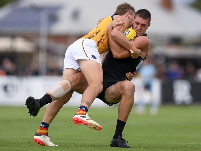 Jordan Dawson of the Crows tackles Jordon Sweet of the Power at Alberton Oval. Picture: Mark Brake/Getty Images